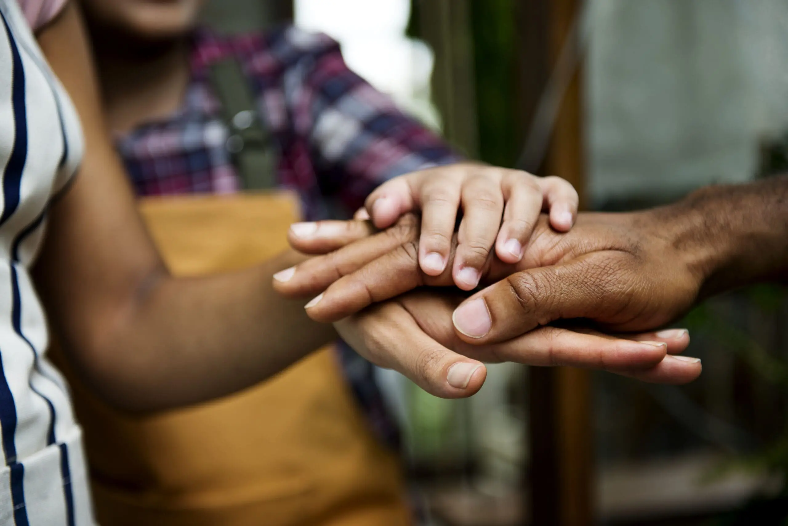 Closeup of diverse hands joined together as teamwork